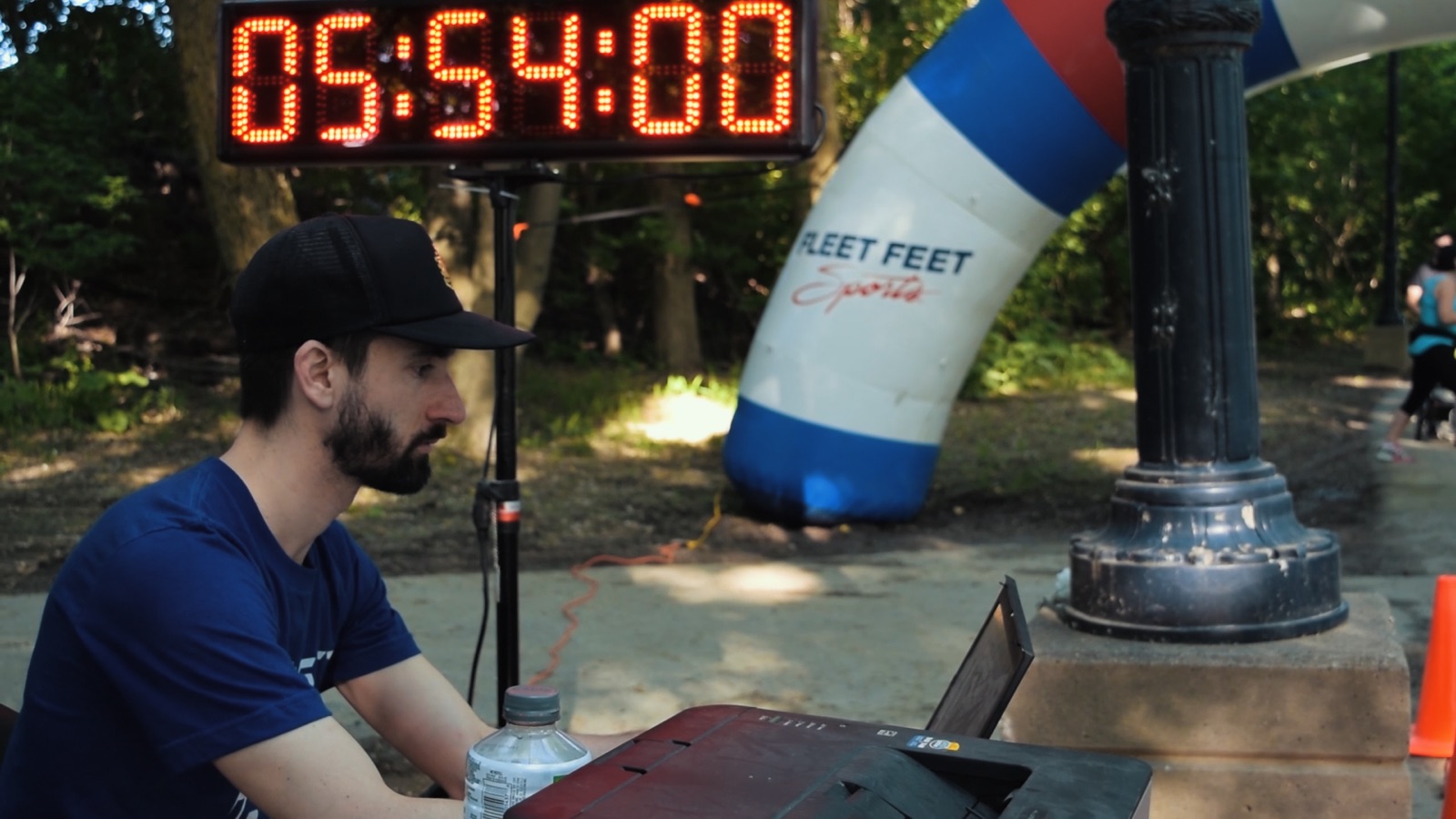 Race timer monitoring finish line with digital display
